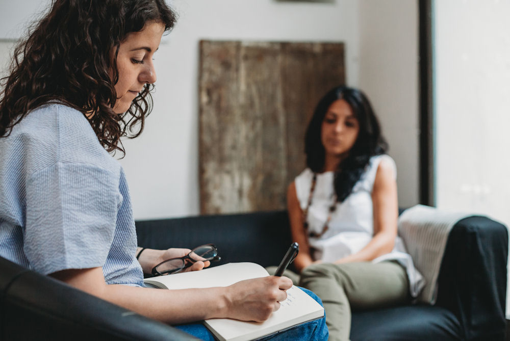 counselor taking notes during therapy