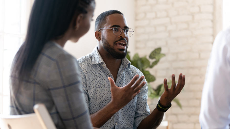 man sharing in group therapy