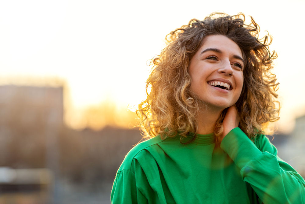 smiling woman wearing green