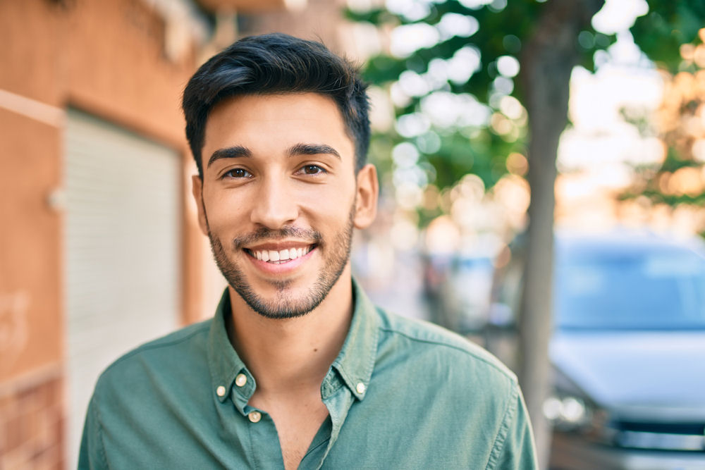 man in recovery standing outside smiling