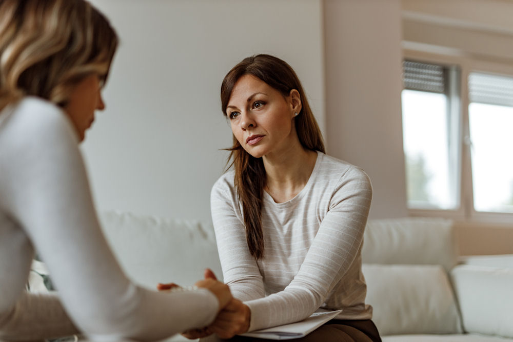 concerned counselor sitting with client