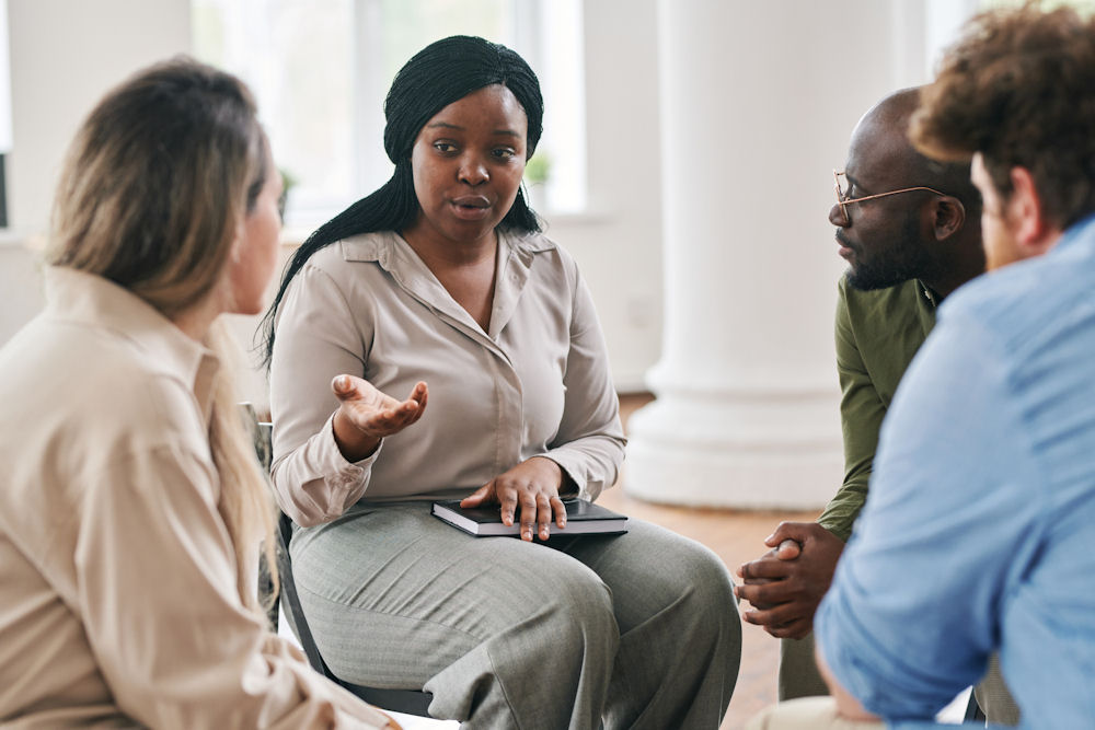 female counselor guiding group session