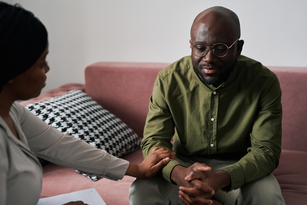 man in therapy sitting on a couch