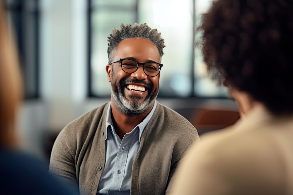 man smiling in therapy session