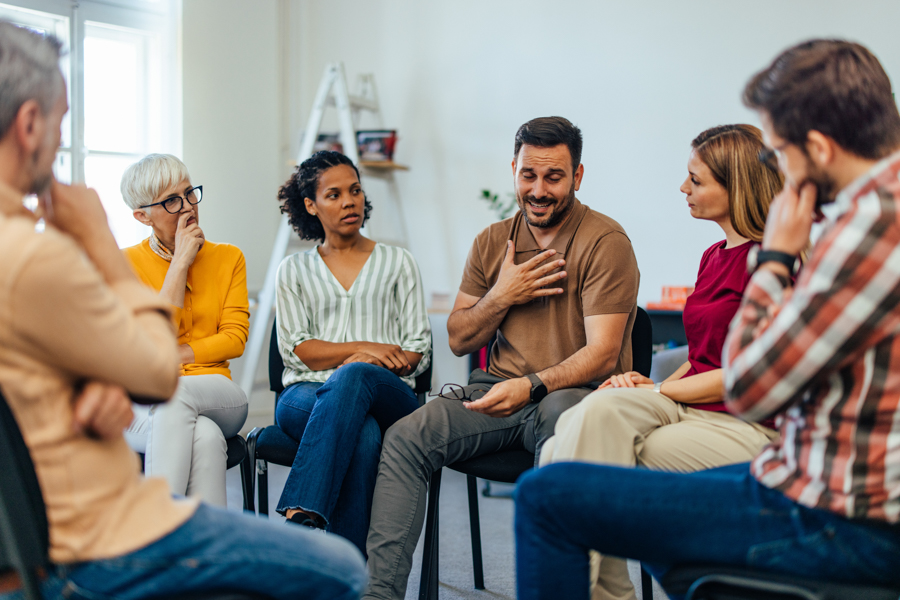 man sharing in alcohol rehab group