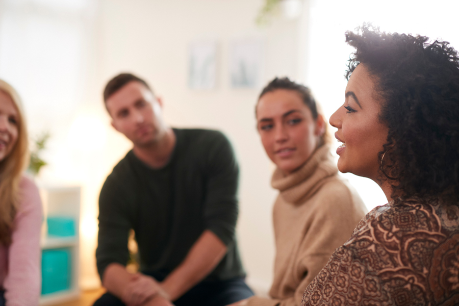 woman speaking during group therapy